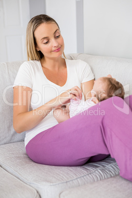 Mother playing with her baby in bedroom