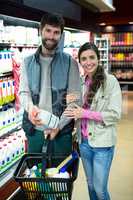 Portrait of couple shopping in grocery section