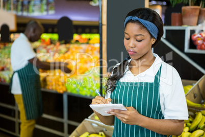 Female staff writing on notepad