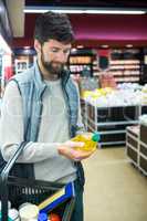 Man holding oil bottle shopping basket