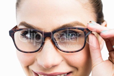 Portrait of beautiful woman posing with spectacles against white background