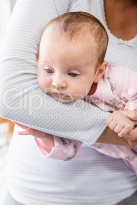 Mid-section of mother holding her baby boy