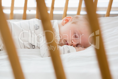 Baby boy sleeping on a cradle