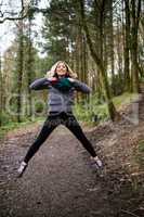Beautiful woman jumping in forest