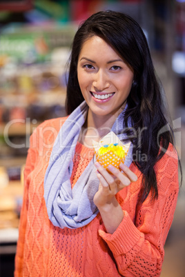 Portrait of woman holding cupcake
