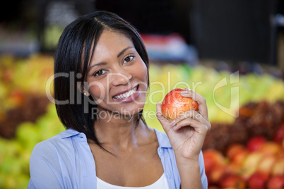 Portrait of beautiful woman holding an apple