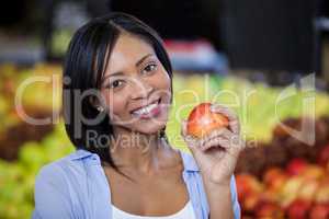 Portrait of beautiful woman holding an apple