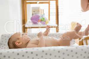 Baby lying on baby bed