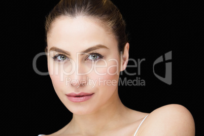 Portrait of beautiful woman posing against black background