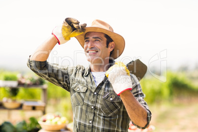Farmer carrying shovel