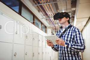 Student in virtual reality headset using digital tablet in locker room