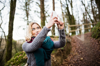 Beautiful woman taking selfie on mobile phone