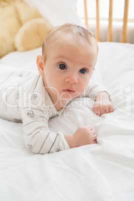 Baby lying on baby bed