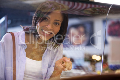 Excited woman pointing at display