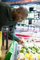Man looking at goods in grocery section while shopping