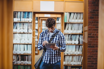 Student using digital tablet in library