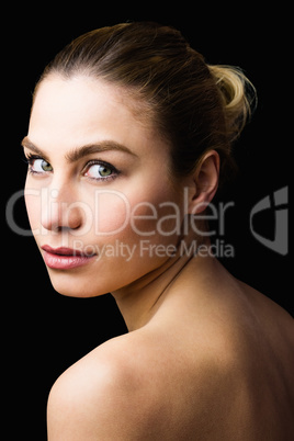 Portrait of beautiful woman posing against black background