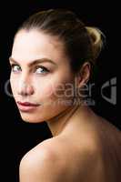 Portrait of beautiful woman posing against black background