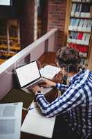 Student using laptop in library