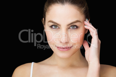 Portrait of beautiful woman posing against black background