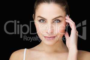 Portrait of beautiful woman posing against black background