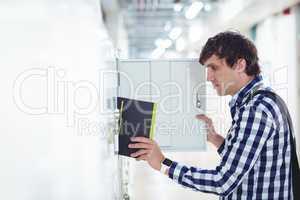 Student keeping his book in the locker