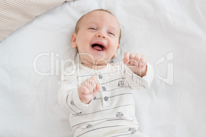 Cute baby boy relaxing on bed