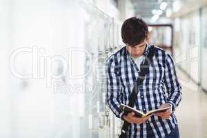 Student reading a book in the locker room