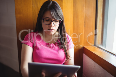 Female student using digital tablet