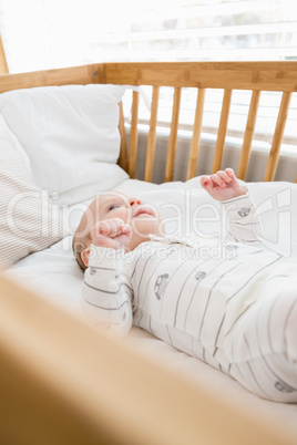Baby boy relaxing on a cradle