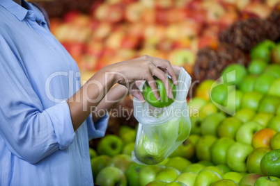 Woman buying an apple