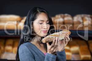 Woman smelling a baguette