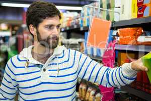 Man selecting a grocery product from shelf