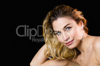 Portrait of beautiful woman posing against black background