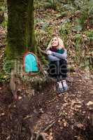 Beautiful woman sitting in forest
