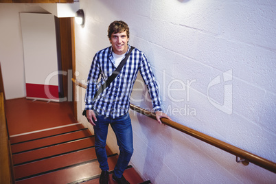 Student standing on staircase