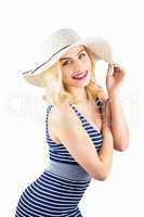 Portrait of beautiful woman posing with hat against white background