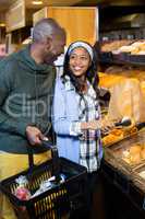 Smiling couple purchasing bread