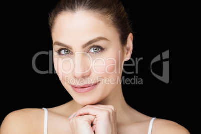 Portrait of beautiful woman posing against black background