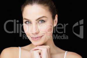 Portrait of beautiful woman posing against black background