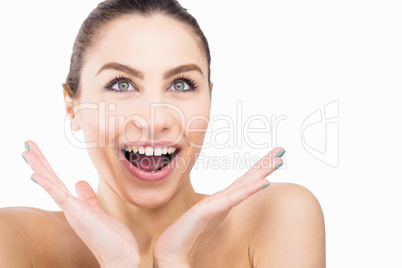 Beautiful woman posing with shocked expression against white background