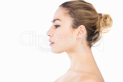 Side view of beautiful woman posing against white background