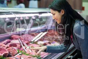 Woman pointing at meat in display