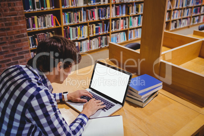 Student using laptop in library