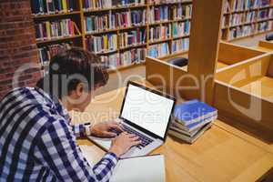 Student using laptop in library