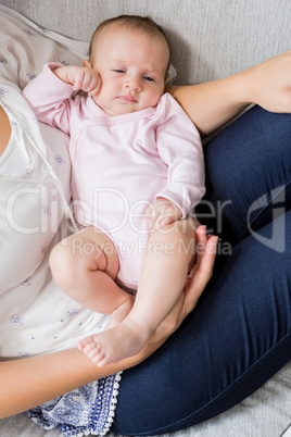 Mother carrying her baby in living room