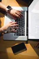 Female student using laptop in library