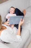 Mother showing digital to her baby in living room