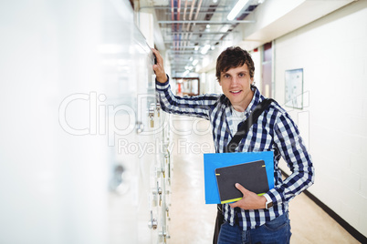 Portrait of student standing in locker room