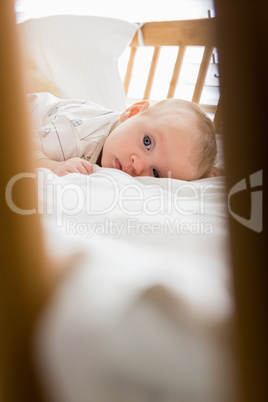 Baby lying on baby bed